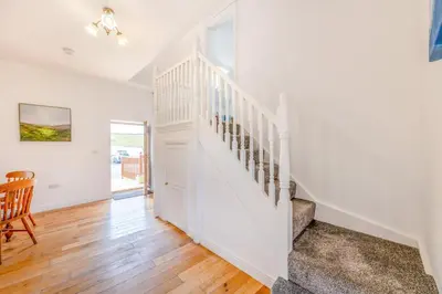 a staircase in a home with white walls and wooden floors at 2 Bed in Rhoslefain oc-i30763 in Llangelynin
