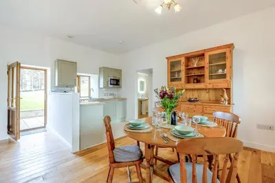 a kitchen and dining room with a table and chairs at 2 Bed in Rhoslefain oc-i30763 in Llangelynin