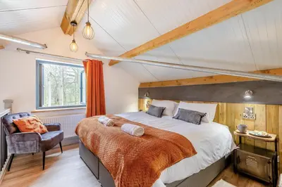 a bedroom with a large bed and a chair at 1 Bed in Berriew oc-a31113 in Berriew