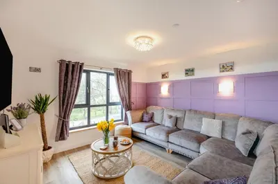 a living room with a couch and a table at 4 Bed in Berriew oc-t31114 in Berriew