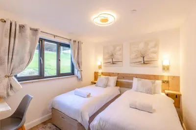 two beds in a room with a window at 4 Bed in Berriew oc-t31114 in Berriew