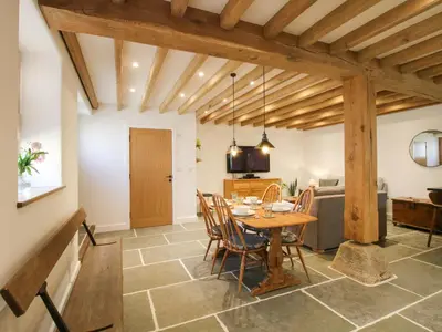 a kitchen and dining room with a table and chairs at The Hideaway in Bishops Castle