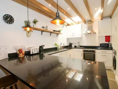 a kitchen with a large black counter top at The Hideaway in Bishops Castle
