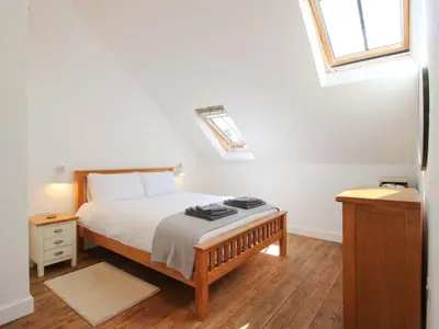 a bedroom with a bed and a window at The Hideaway in Bishops Castle