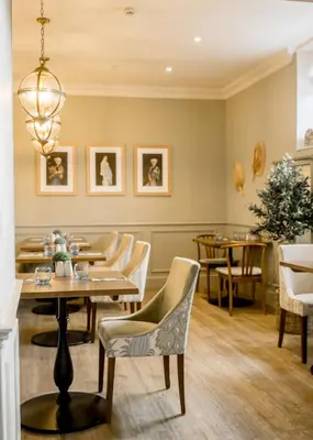 a restaurant with tables and chairs and a dining room at Sweeney Hall Hotel in Oswestry