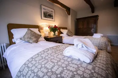 a bedroom with two beds with towels on them at Y Castell in Llangadog