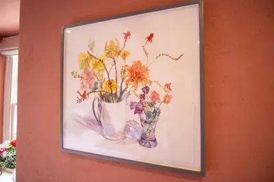 a painting of flowers in a vase on a wall at Y Castell in Llangadog