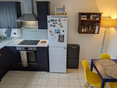 a kitchen with a white refrigerator and a table at Number 46 in Bicton