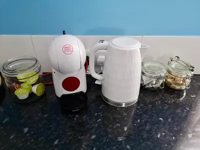 a white coffee maker sitting on a counter with jars at The Loft - Shrewsbury in Shrewsbury