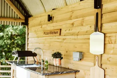 an outdoor kitchen with a counter and a sink at Shepherd's Hut at Lythwood, Near Shrewsbury in Baystonhill
