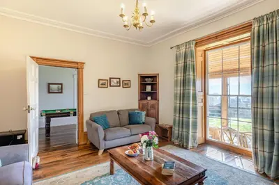 a living room with a couch and a table at 5 Bed in Hundred House oc-l31090 in Hundred House