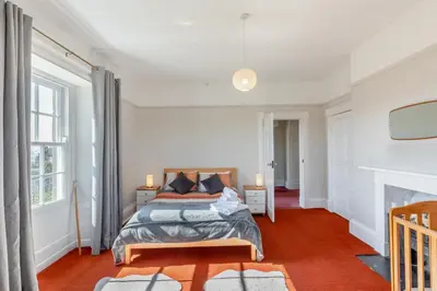 a bedroom with a bed and two windows at 5 Bed in Hundred House oc-l31090 in Hundred House