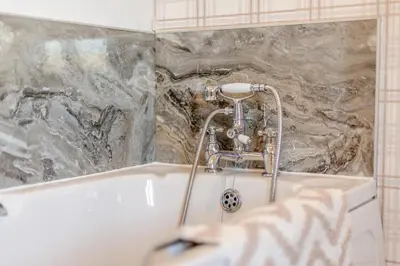 a bath tub with a faucet in a bathroom at 5 Bed in Hundred House oc-l31090 in Hundred House