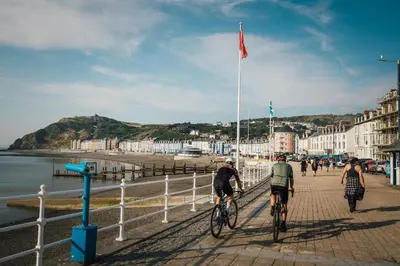a group of people riding bikes on the beach at 5 Bed in Ystrad Meurig oc-r31133 in Ystrad Meurig