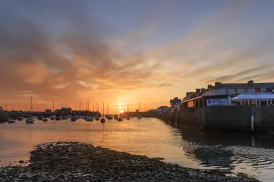 a sunset over a body of water with boats at 5 Bed in Ystrad Meurig oc-r31133 in Ystrad Meurig