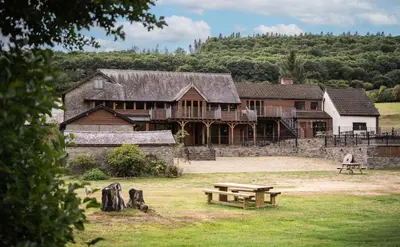 a large house with a picnic table in front of it at Stud Farm House in Bleddfa