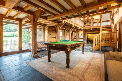 a pool table in a room with wooden ceilings at Stud Farm House in Bleddfa