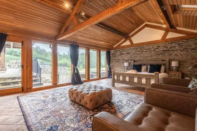 a large living room with a bed and a couch at Stud Farm House in Bleddfa