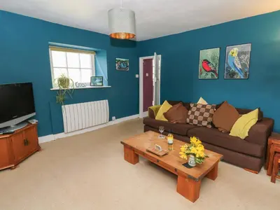 a living room with a couch and a coffee table at Cantref House Top Floor in Brecon
