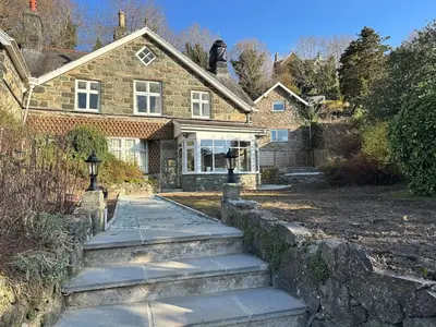 a brick house with some stairs in front of it at Cil-y-Coed in Dolgellau