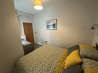 a bedroom with a bed and a picture on the wall at Cil-y-Coed in Dolgellau