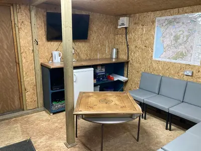 a room with a table and a couch and a map at Tyn-Y-Berth Sleeps 27 luxury group accommodation in Tal-y-llyn