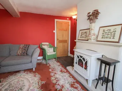 a living room with a couch and a fireplace at 10 Upper Linney in Ludlow