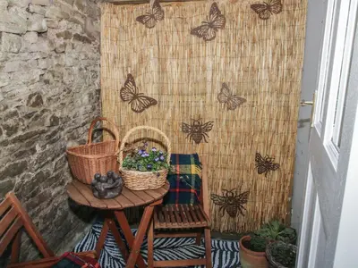 a table with two baskets and butterflies on a wall at 10 Upper Linney in Ludlow