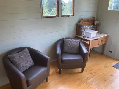 a room with a chair and a desk at Shepherds hut on alpaca farm in Blaenau-Ffestiniog