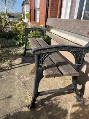 a wooden bench sitting on a sidewalk next to a building at Quintessentially English 3-Bed Home in Ludlow - Pass the Keys in Ludlow