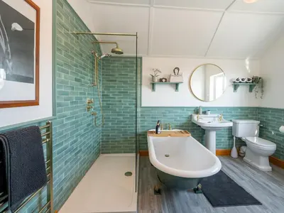 a bathroom with a tub and a toilet and a sink at Quintessentially English 3-Bed Home in Ludlow - Pass the Keys in Ludlow
