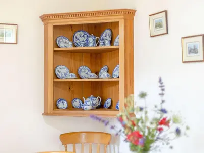 a shelf with blue and white china on it at Swallow's Nest in Craven Arms