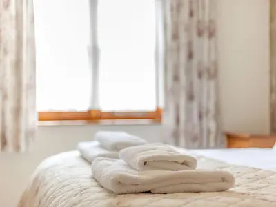 a group of towels sitting on top of a bed at Swallow's Nest in Craven Arms