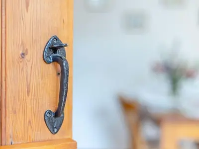 a iron door handle on a wooden door at Swallow's Nest in Craven Arms