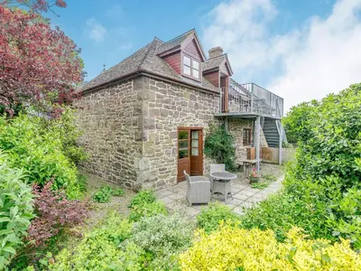 an exterior view of a stone house at Swallow's Nest in Craven Arms