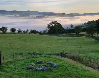 a field with a bunch of rocks in the grass at 4 Bed in Llangower oc-f31072 in Llangower