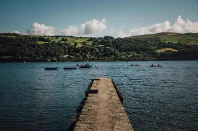 a dock in the middle of a lake with boats at 4 Bed in Llangower oc-f31072 in Llangower