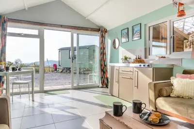 a kitchen and living room with a couch and a table at 1 Bed in Ffestiniog oc-c31093 in Ffestiniog