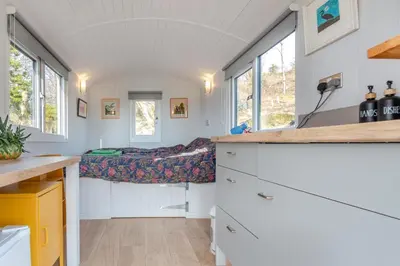 a tiny house with a bed in a room with windows at 1 Bed in Ffestiniog oc-c31093 in Ffestiniog