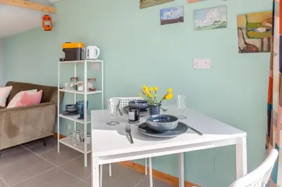 a white table in a room with a couch at 1 Bed in Ffestiniog oc-c31093 in Ffestiniog
