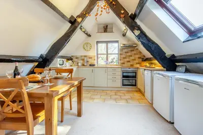 a kitchen with a wooden table and a dining room at 2 Bed in Llangorse oc-p31754 in Llangorse
