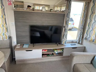 a living room with a television in a rv at Coastal Serenity Escape Clarach Bay Sea Viev Modern 2019 model No Pets in Aberystwyth