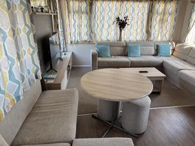 a living room with a couch and a table at Coastal Serenity Escape Clarach Bay Sea Viev Modern 2019 model No Pets in Aberystwyth