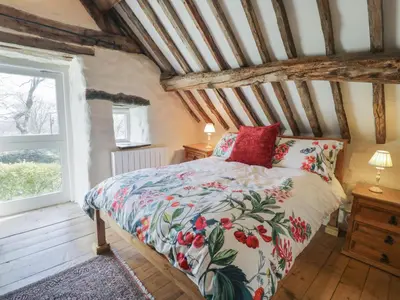 a bedroom with a bed and a window at Old Ty'n Y Wern in Bala