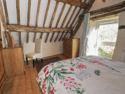 a bedroom with a bed and a desk and a window at Old Ty'n Y Wern in Bala