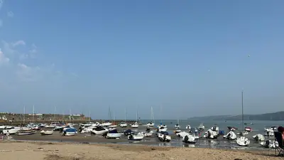 a bunch of boats are parked in a harbor at Gwel y Don 12 Tabenacle Street in Aberaeron