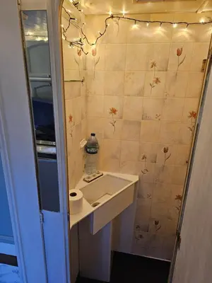 a small bathroom with a sink and a mirror at Cosy Caravan Walkers Ramblers Fishermen Cyclists in Abermule