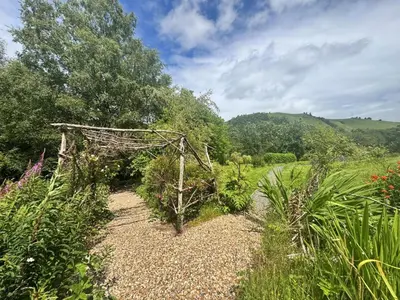a garden with a pergola in a field at 4 Bed in Llanidloes oc-95968 in Van