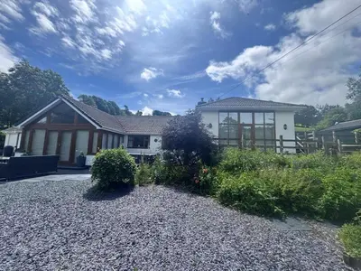 a house with a garden in front of it at 4 Bed in Llanidloes oc-95968 in Van