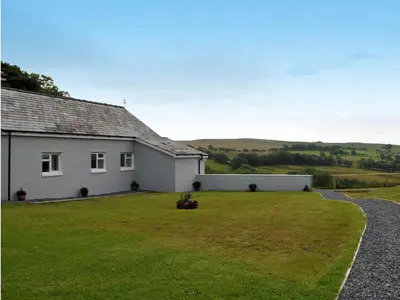a white house with a large lawn in front of it at Llaethdy Rachel Lampeter in Aberaeron